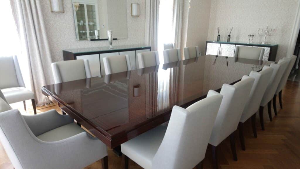 Completely restored Baker Thomas Pheasant dining table with matching upholstered dining chairs, showcasing the refined lines and premium craftsmanship of the Thomas Pheasant collection.